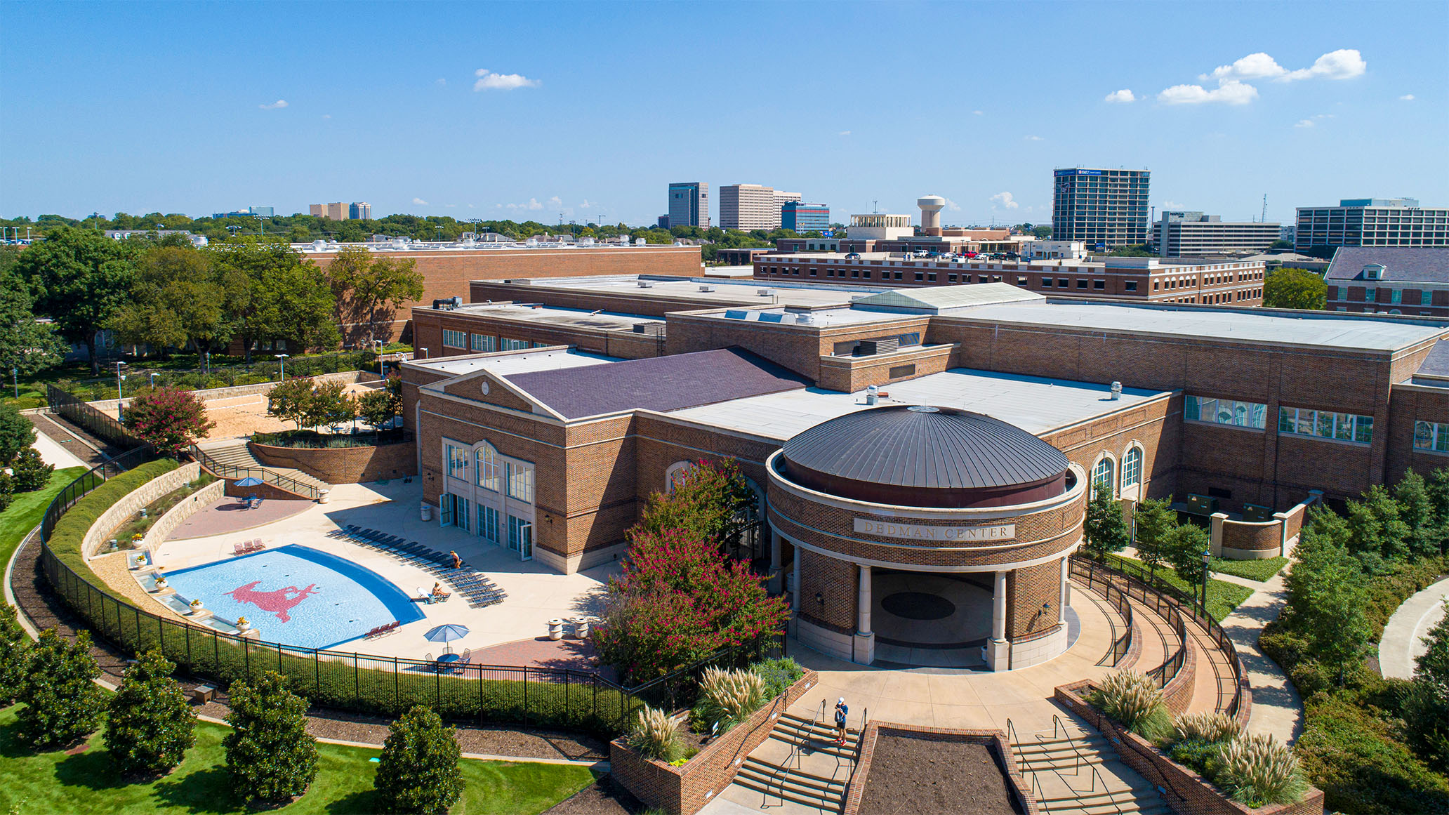 exterior of the Dedman Center for Lifetime Sports building with tanning pool on the SMU campus