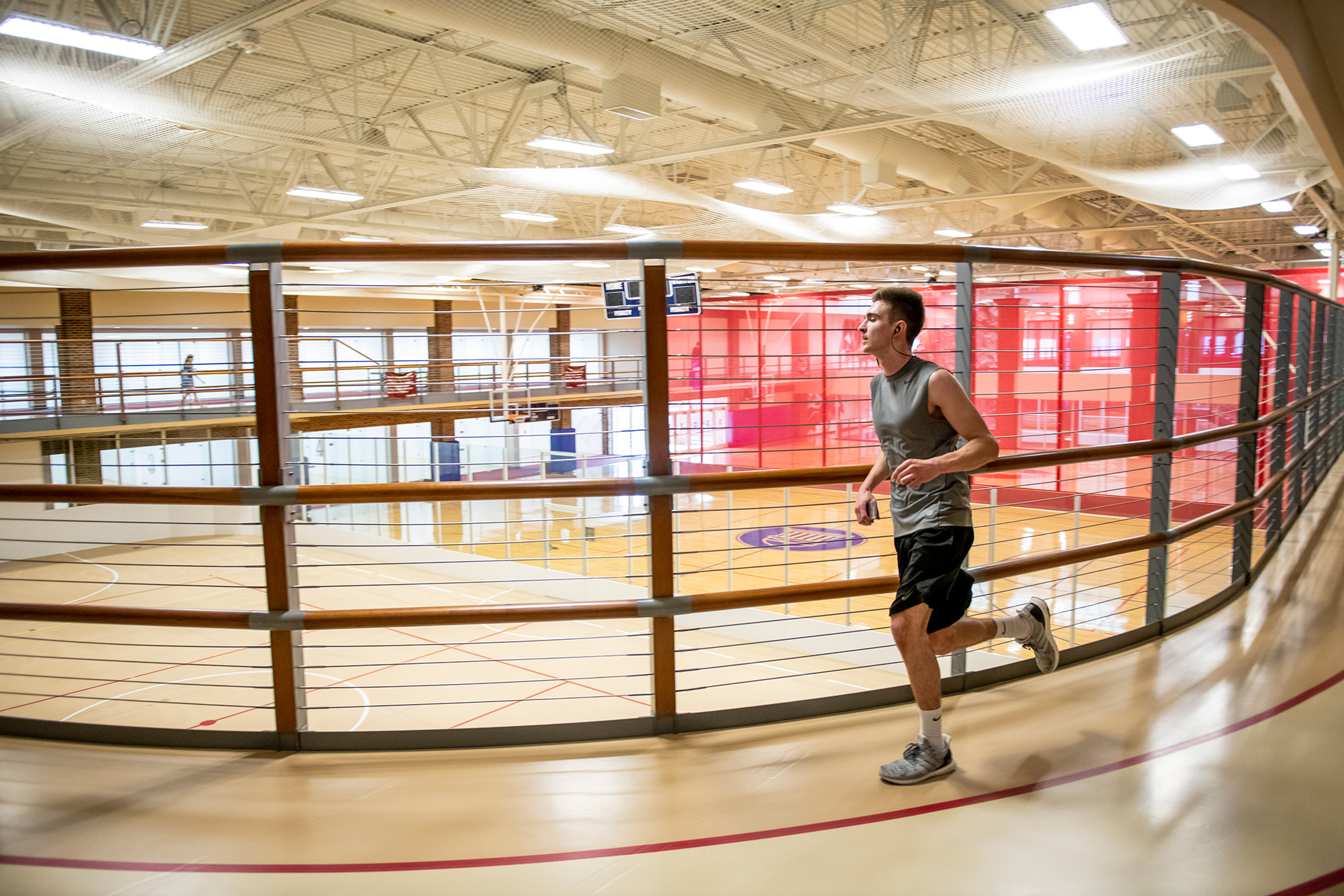 person running around indoor track