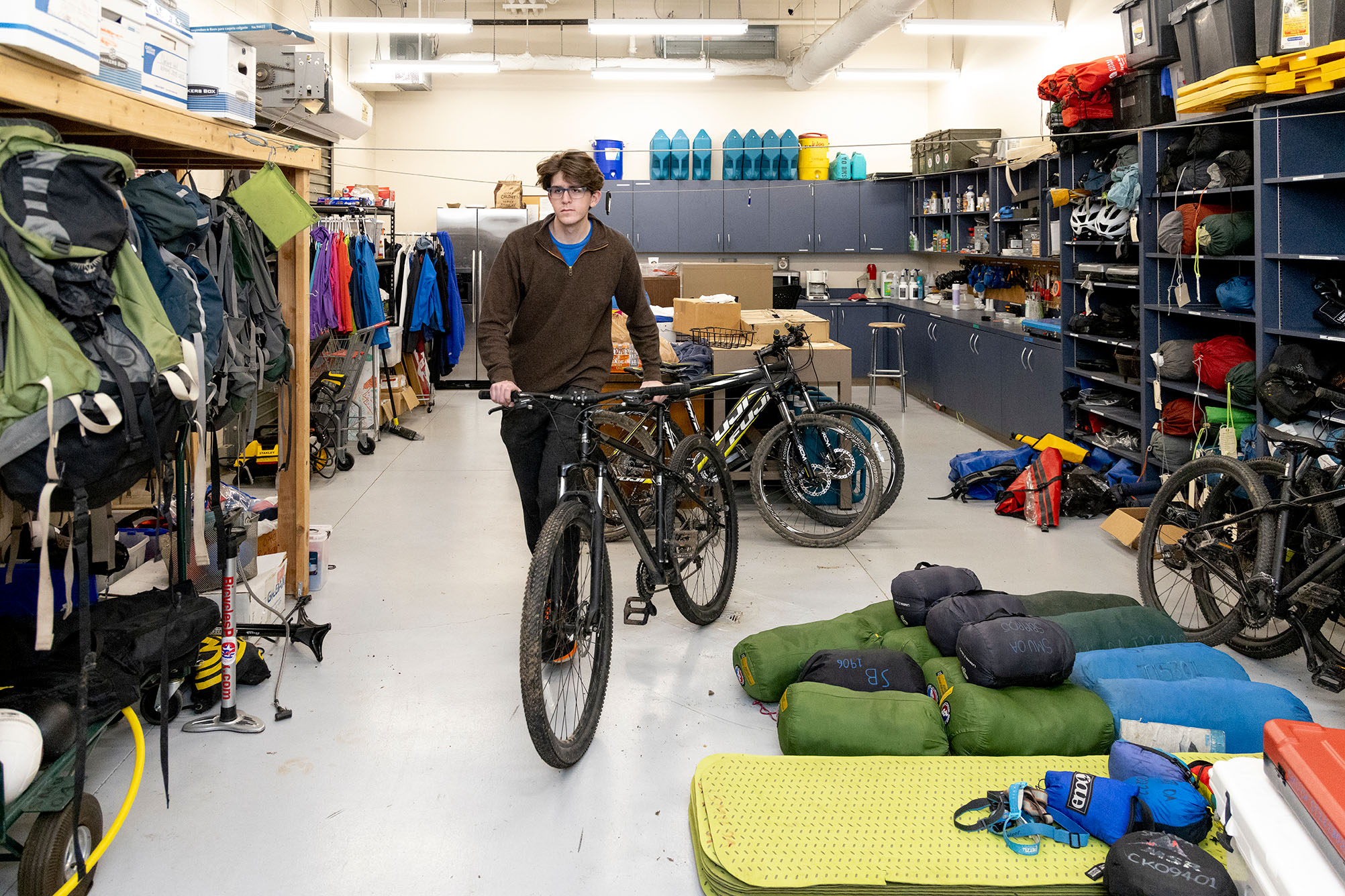 person with bicycle inside equipment center