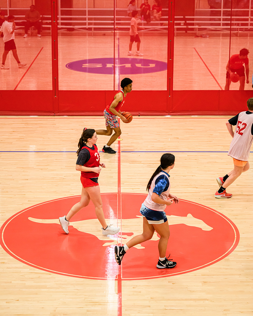 students playing basketball on indoor court