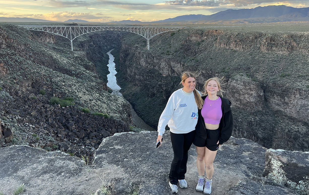 Two SMU-in-Taos students stand together near the canyon rim.