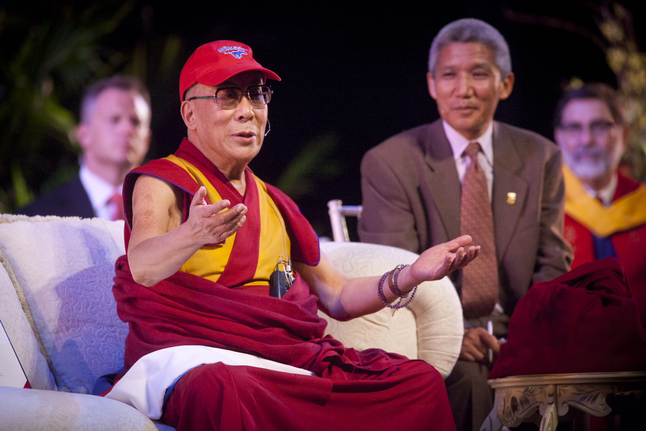 The Dalai Lama wearing an SMU baseball cap.