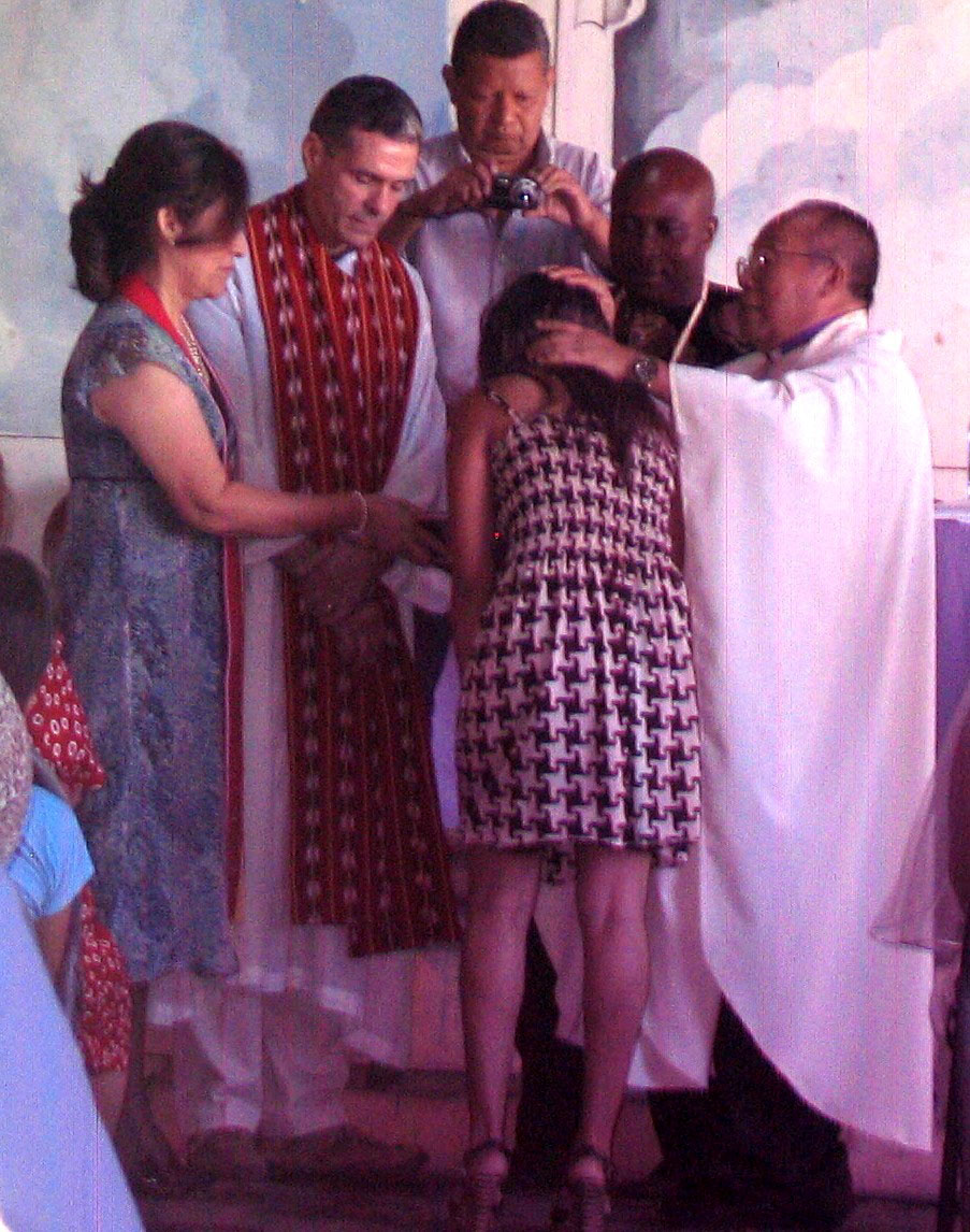 Bishop Medardo Gomez (right) at a baptism in El Salvador, with Perkins Professor Harold Recinos (second from left). 
