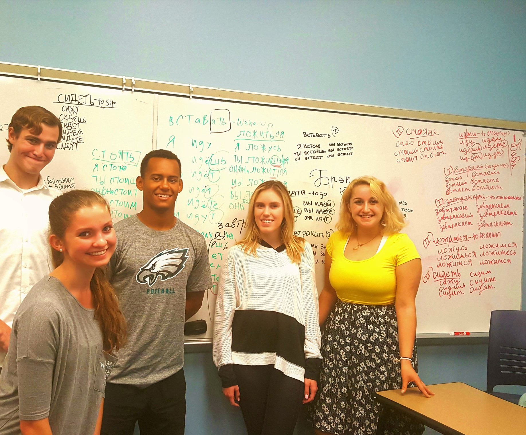 Students standing in front of a whiteboard