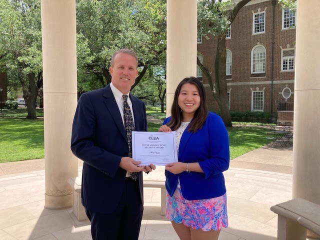 SMU Law Tax Clinic Director Greg Mitchell and Amy Nguyen holding a CLEA certificate.