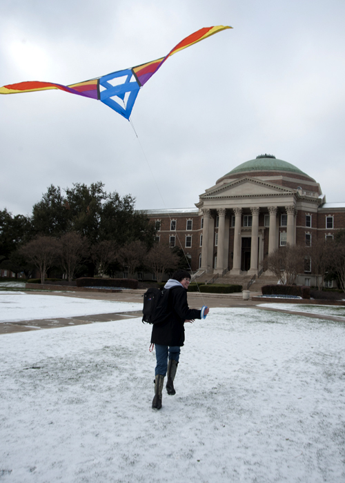 SMU student flying a kite in the snow on the main quad