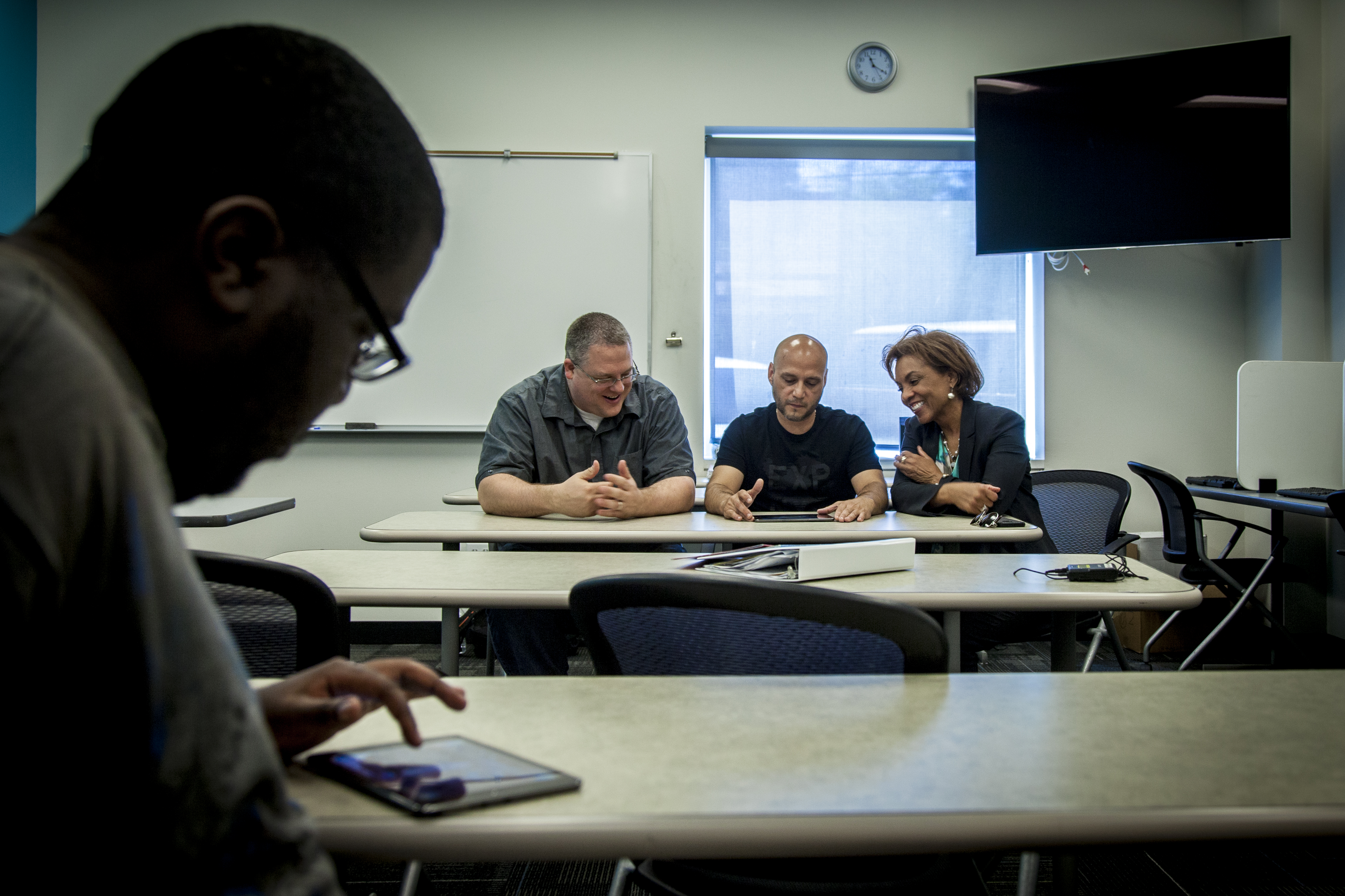 LIFT students Damon Richardson (foreground), and Jesus Santos (center) tested beta versions of the game last spring, providing valuable feedback to Corey Clark, SMU Guildhall Deputy Director for Research (left) and Lisa Hembry, LIFT CEO/president, (right).