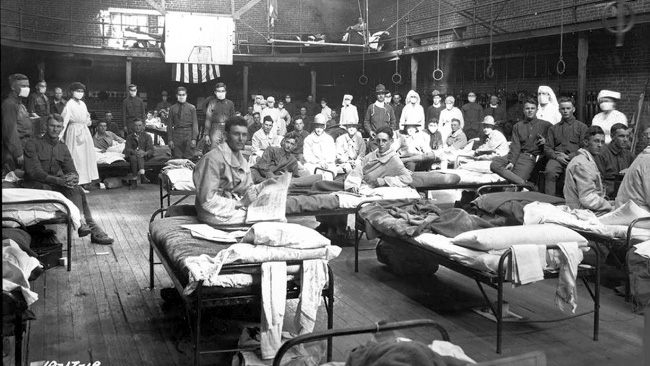 Soldiers with the Spanish flu are hospitalized inside the U. of Kentucky gym in 1918. Photo courtesy of U. of Kentucky