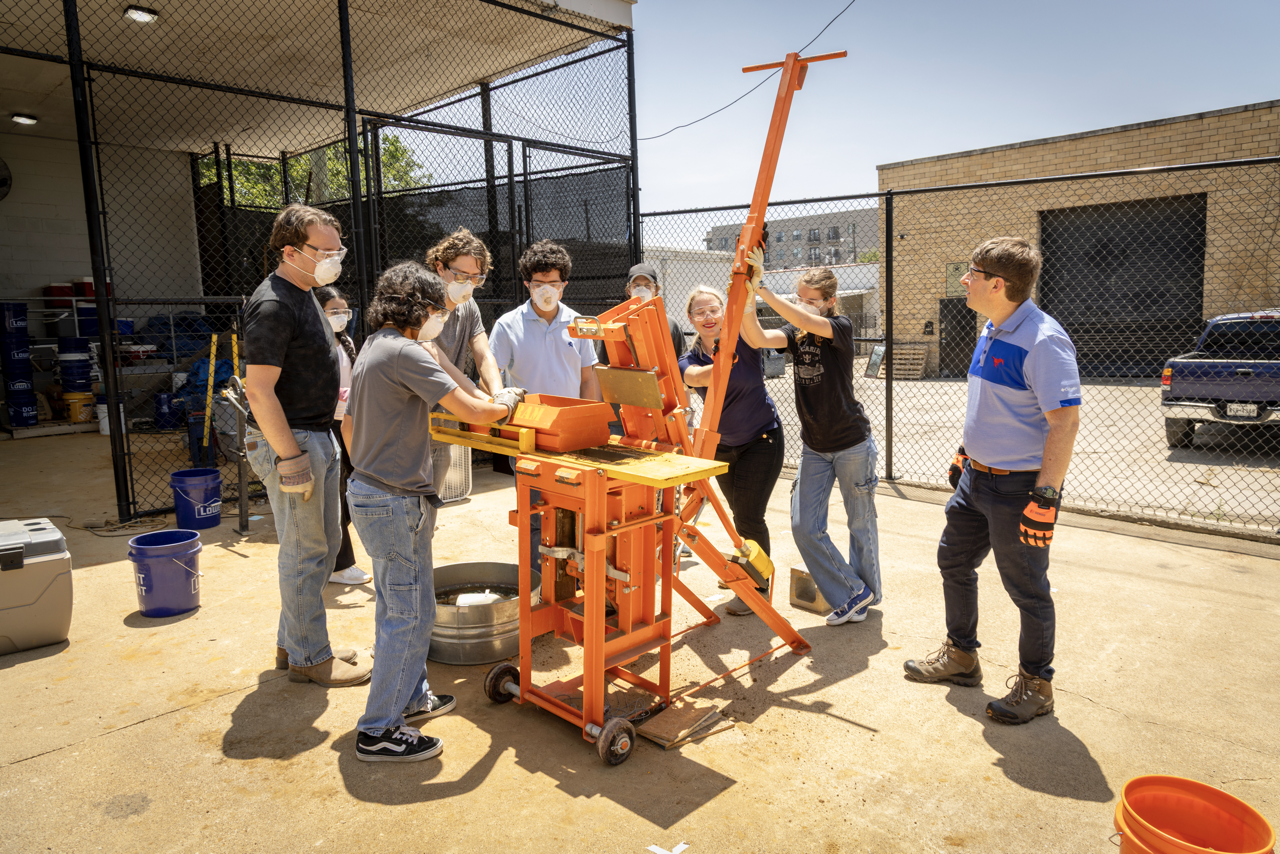 The muddy mixture is poured into a mold and compressed. Photo by SMU