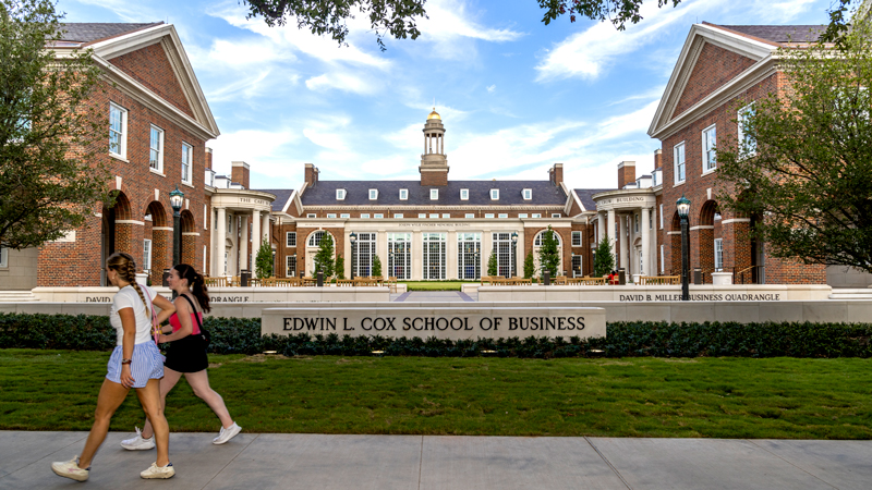 Students walking in front of the Edwin L. Cox School of Business