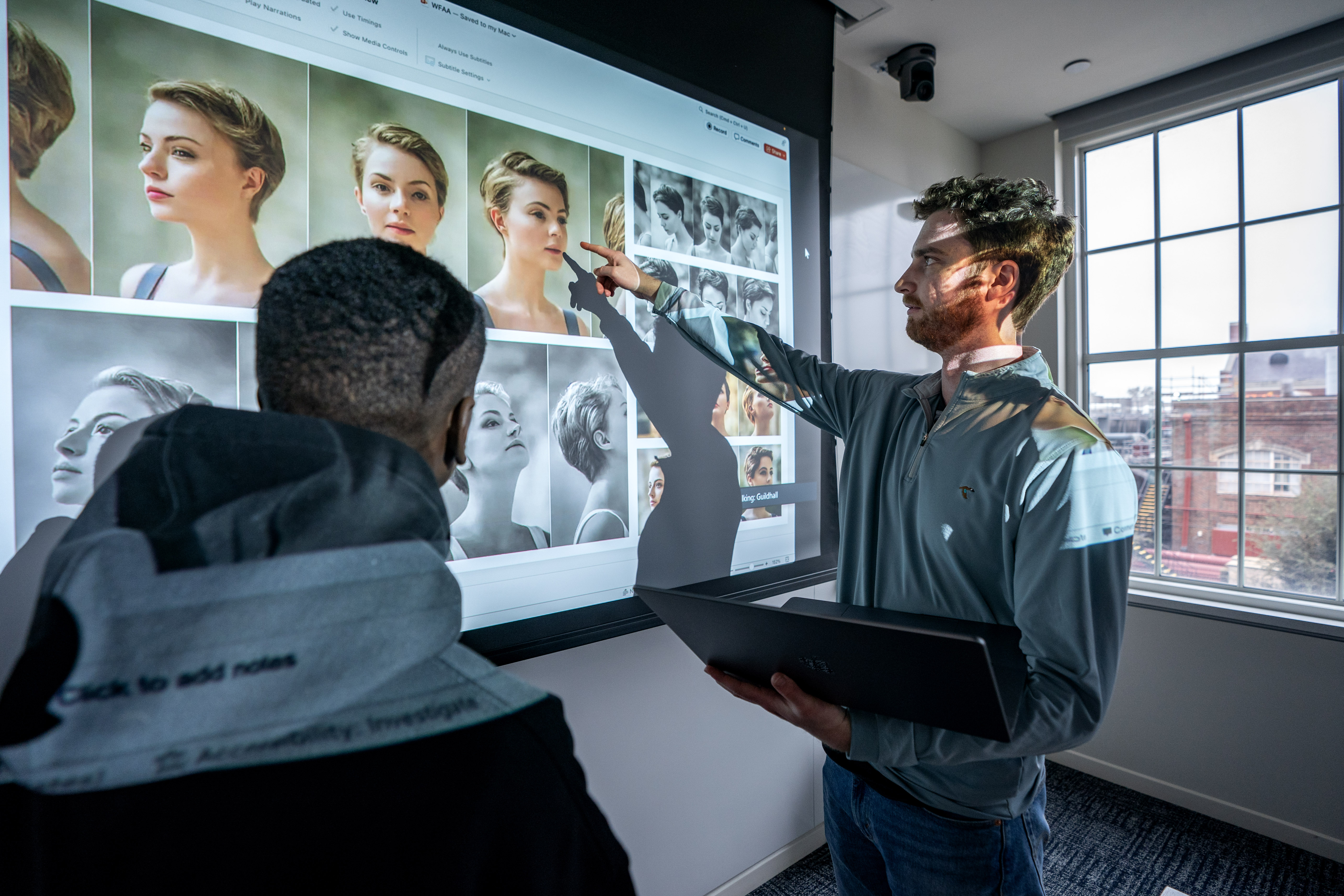 SMU researchers review image files on a projection screen